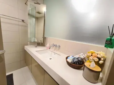 a bathroom with a sink and a mirror at Comfortable Zone in Khlong Toei