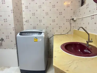 a bathroom with a sink and a waste basket at Bangkok Phomphong Villa\u8054\u6392\u6cf0\u5f0f\u522b\u5885 in Bangkok