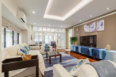 a living room with a couch and a fireplace at Luxurious 6BR Villa with Pool & Games at Sukhumvit in Bangkok