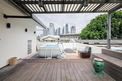 an outdoor deck with a view of the city at Luxurious 6BR Villa with Pool & Games at Sukhumvit in Bangkok
