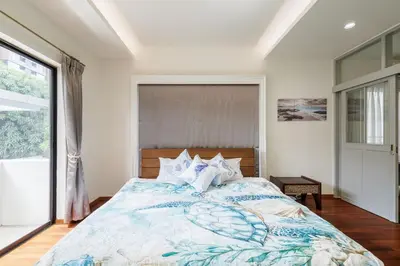 a bedroom with a bed and a large window at Luxurious 6BR Villa with Pool & Games at Sukhumvit in Bangkok