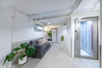 a living room with a couch and some plants at Petchaburi22 Apartments next to Platinum mall in Bangkok