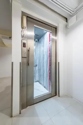 an elevator door in a room with a window at Petchaburi22 Apartments next to Platinum mall in Bangkok