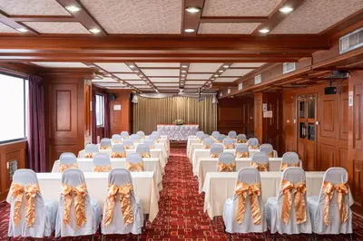 a room with rows of tables and chairs in it at Elizabeth Hotel in Bangkok