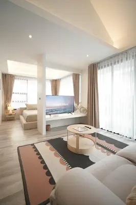 a living room with a couch and a tv at Somewhere house in Bangkok
