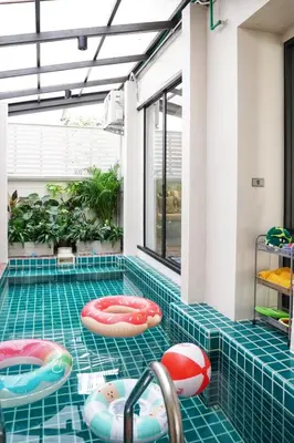 a swimming pool with inflatables in a house at Somewhere house in Bangkok