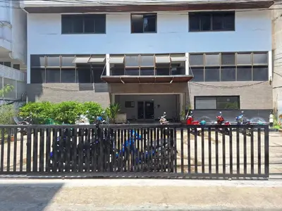 a building with motorcycles parked in front of a fence at 24 Apt in Bangkok