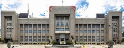 a large building with a fountain in front of it at 24 Apt in Bangkok