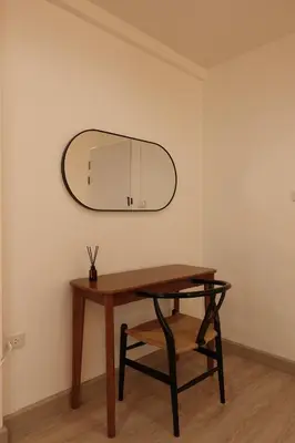 a table and a mirror on a wall at 24 Apt in Bangkok