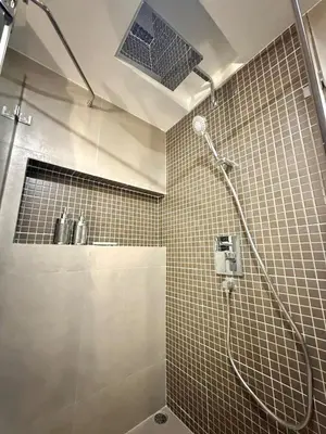 a bathroom with a shower with a shower head at Peaceful Cozy Apt with Stunning View&Full Kitchen in Bangkok
