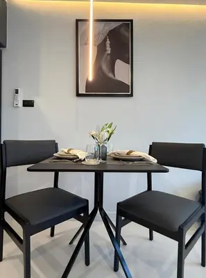 a dining room table with two chairs and a black table at Peaceful Cozy Apt with Stunning View&Full Kitchen in Bangkok