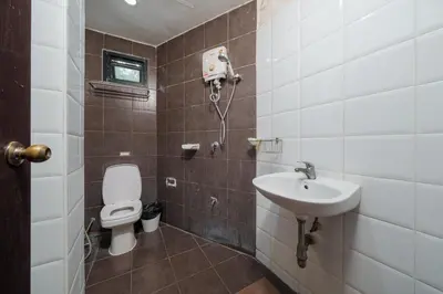 a bathroom with a toilet and a sink at Collection O Khaosan Park in Bangkok