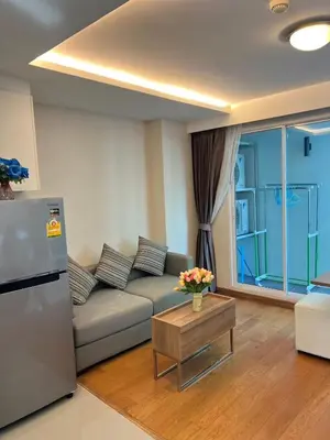 a living room with a couch and a table at CozyroomSukumvit13walktoBTS,MRT in Bangkok