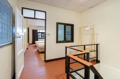 a room with a staircase and a living room at OH Homes - Samsen 10 in Bangkok