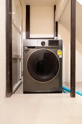 a washer and dryer sitting in a room at OH Homes - Samsen 12 in Bangkok