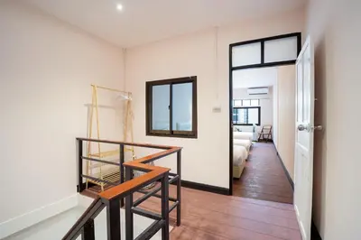 a room with a staircase and a room with a bedroom at OH Homes - Samsen 12 in Bangkok