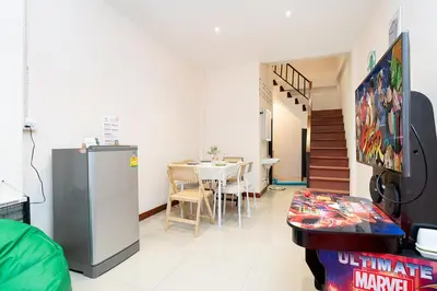 a living room with a refrigerator and a table at OH Homes - Samsen 12 in Bangkok