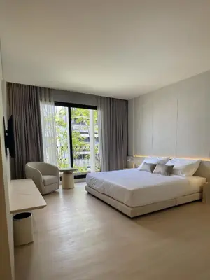 a bedroom with a large bed and a large window at Chinatown Heritage, Chinatown Main road in Samphanthawong