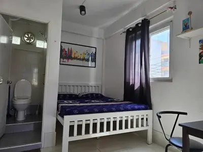 a small bedroom with a bed and a toilet at Jatujak Bangkok guesthouse R5 in Sathani Bang Su