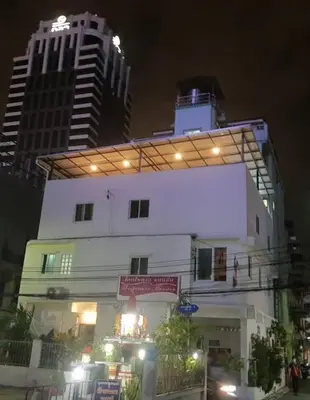 a building with lights on top of it at night at Jatujak Bangkok guesthouse R5 in Sathani Bang Su