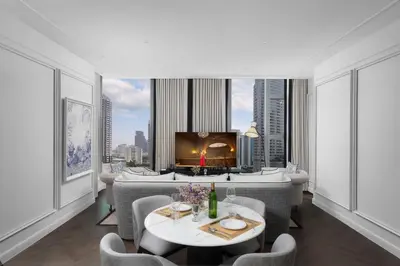 a dining room with a view of a city at La Clef Bangkok by The Crest Collection in Bangkok