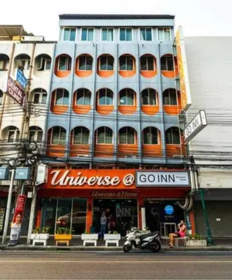 a large building with orange windows on a city street at XX GO INN Khaosan ตรอกข้าวสาร สนามหลวง in Bangkok