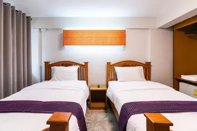 two beds in a hotel room with twothirdsessions at XX GO INN Khaosan ตรอกข้าวสาร สนามหลวง in Bangkok