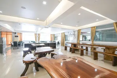 a dining room with wooden tables and chairs at AC Habitat Bangkok in Bangkok