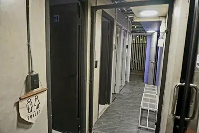 a hallway of a building with a sign on the wall at Silom Soi 3 Hash Hostel in Bangkok
