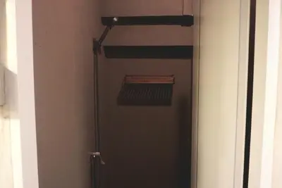 a door with a shelf in a room at Silom Soi 3 Hash Hostel in Bangkok