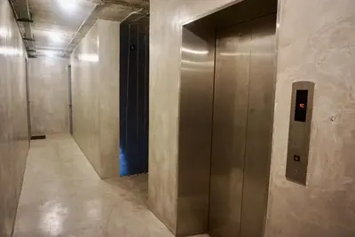 a hallway with a elevator in a building at Silom Soi 3 Hash Hostel in Bangkok