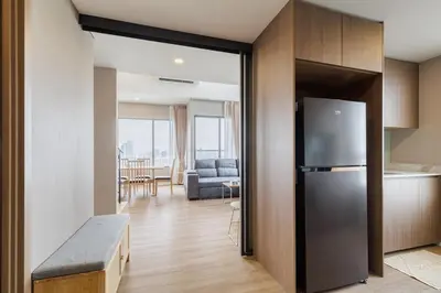 a kitchen with a refrigerator and a living room at loft \u6cf3\u6c60\u516c\u5bd3 \u4e09\u623f\u4e8c\u536b \u514d\u8d39WiFi in Bangkok