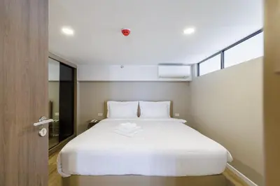 a bedroom with a large white bed and a window at loft \u6cf3\u6c60\u516c\u5bd3 \u4e09\u623f\u4e8c\u536b \u514d\u8d39WiFi in Bangkok