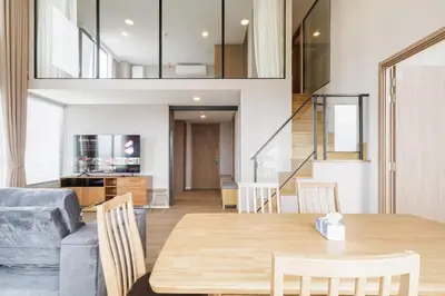 a dining room and living room with a wooden table at loft \u6cf3\u6c60\u516c\u5bd3 \u4e09\u623f\u4e8c\u536b \u514d\u8d39WiFi in Bangkok