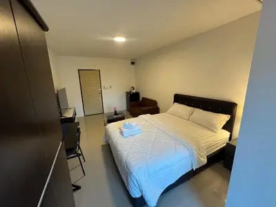 a bedroom with a bed with a blue towel on it at ณัฐพิมลเพลส์ 3 in Bangkok Yai