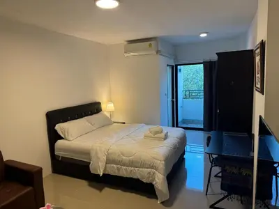 a bedroom with a bed and a window at ณัฐพิมลเพลส์ 3 in Bangkok Yai