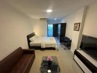 a small living room with a bed and a couch at ณัฐพิมลเพลส์ 3 in Bangkok Yai