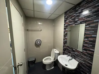 a bathroom with a toilet and a sink and a mirror at ณัฐพิมลเพลส์ 3 in Bangkok Yai