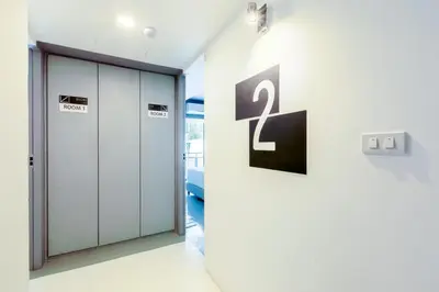 a hallway with two lockers and a number on a wall at 24 degree hotel & hostels in Bangkok