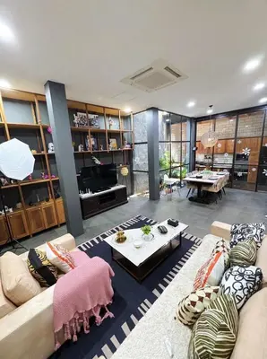 a living room with two couches and a table at Bangkok Thailand Core Business District 3b3b Duplex Private House Family Room Cooking Smoking Nursery in Bangkok