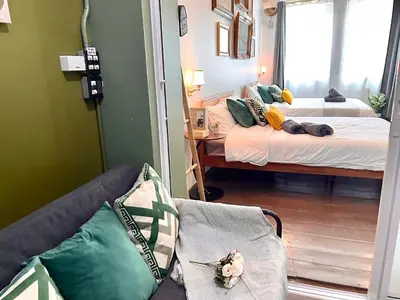 a room with two beds and a couch and a mirror at Entire house,Unwind in the city, near GrandPalace in Bangkok