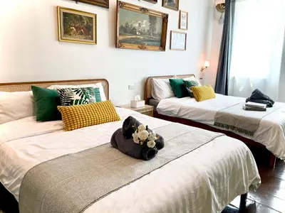 a room with three beds with a stuffed animal on the middle at Entire house,Unwind in the city, near GrandPalace in Bangkok