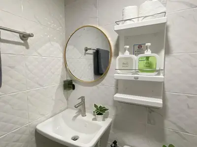 a white bathroom with a sink and a mirror at Entire house,Unwind in the city, near GrandPalace in Bangkok
