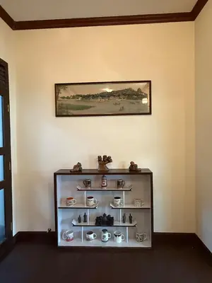 a shelf in a room with a picture on the wall at Luan Heritage Surawong in Bangkok