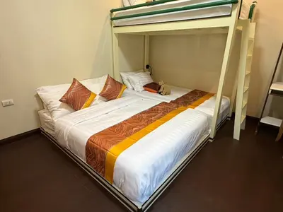 a bed in a room with a bunk bed at Luan Heritage Surawong in Bangkok