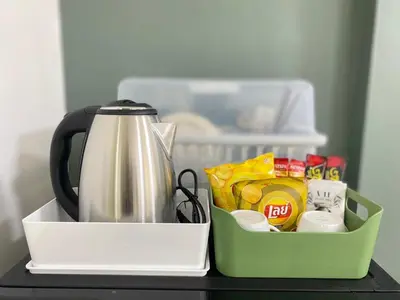 a tea kettle and a container on a table at La Maison 230 in Ban Khlong Samrong