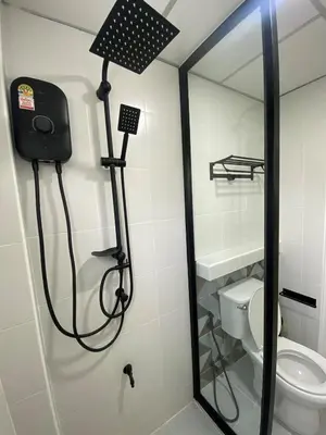 a shower in a bathroom with a toilet at Homey Place in Ban Song Hong