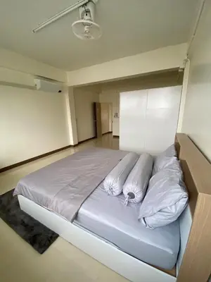 a bedroom with a large bed with white pillows at Homey Place in Ban Song Hong