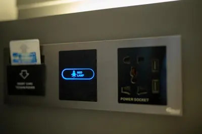 a microwave oven with a blue sign on it at The Chedee Krungthep in Bangkok