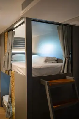 a bedroom with a bunk bed with a mirror at The Chedee Krungthep in Bangkok
